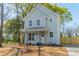 Charming two-story home with a light blue exterior, wooden porch supports, and a well-manicured front yard at 574 Reid St, Belmont, NC 28012