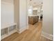 Hallway view into a modern kitchen featuring white cabinets and a center island, complemented by a built-in bench at 574 Reid St, Belmont, NC 28012