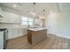 Contemporary kitchen features white cabinets, a center island, a stainless steel oven, and modern finishes at 574 Reid St, Belmont, NC 28012