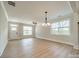 Bright and airy living room with hardwood floors, a ceiling fan, and large windows for natural light at 574 Reid St, Belmont, NC 28012