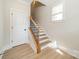 Bright stairway featuring wood stairs, iron railings, and natural light from a window at 574 Reid St, Belmont, NC 28012