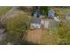 Aerial view of a home with a fenced backyard, a concrete driveway, and surrounding trees at 576 Reid St, Belmont, NC 28012