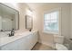 Bright bathroom featuring double sinks, modern fixtures, large mirrors, and neutral color palette at 576 Reid St, Belmont, NC 28012