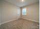 Bedroom featuring neutral walls, carpeted floor, and a bright window at 576 Reid St, Belmont, NC 28012