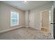 Bright bedroom with neutral walls, carpet, and natural light at 576 Reid St, Belmont, NC 28012
