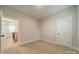 Light-filled bedroom with carpet, neutral walls, and a staircase view at 576 Reid St, Belmont, NC 28012