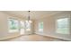 Bright dining area with vinyl floors, modern lighting, and access to the outdoor deck at 576 Reid St, Belmont, NC 28012