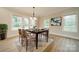 Elegant dining room featuring a modern chandelier, large windows, and neutral decor at 576 Reid St, Belmont, NC 28012