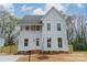 New two-story home with white siding, large windows, a gray roof, and a manicured lawn at 576 Reid St, Belmont, NC 28012