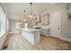 Open-concept kitchen with a central island, pendant lights, and seamless transition to living spaces at 576 Reid St, Belmont, NC 28012