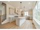 Modern kitchen with a large island, white cabinets, and stainless steel appliances at 576 Reid St, Belmont, NC 28012