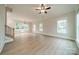 Spacious living room with vinyl flooring, a modern ceiling fan, and ample natural light at 576 Reid St, Belmont, NC 28012