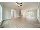 Expansive living area with vinyl flooring, a modern ceiling fan, and an open floor plan at 576 Reid St, Belmont, NC 28012
