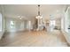 Open-concept living space with vinyl floors, a kitchen island, and lots of natural light at 576 Reid St, Belmont, NC 28012
