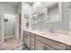 Bright bathroom featuring double sinks, white countertops, and a walk-in closet at 7133 Yardley St, Gastonia, NC 28056