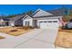 Charming home with a well-kept lawn, a two-car garage, and a classic American flag displayed at 7133 Yardley St, Gastonia, NC 28056