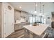 Bright kitchen featuring gray cabinets, stainless appliances, a center island and hardwood floors at 7133 Yardley St, Gastonia, NC 28056