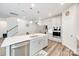 Bright modern kitchen with white quartz counters, stainless appliances, large island and hardwood floors at 7133 Yardley St, Gastonia, NC 28056