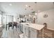 Open concept: island kitchen with hardwood floors that looks onto dining room and living room area at 7133 Yardley St, Gastonia, NC 28056