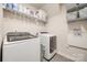 Well-organized laundry room featuring a modern washer and dryer set with overhead storage shelves at 7133 Yardley St, Gastonia, NC 28056