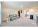 Spacious living area with a sofa, neutral carpet, and a view to the entry at 7133 Yardley St, Gastonia, NC 28056