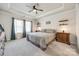 This is a main bedroom with a ceiling fan, large bed, and lots of natural light from the windows at 7133 Yardley St, Gastonia, NC 28056
