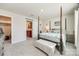 Bright bedroom boasts a four-poster bed and neutral decor, adjacent to the walk-in closet at 7133 Yardley St, Gastonia, NC 28056