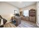 Home office with wood floors, desk, and built-in shelving at 7133 Yardley St, Gastonia, NC 28056