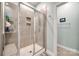 Modern bathroom showcasing a sleek glass-enclosed shower and neutral tile at 7133 Yardley St, Gastonia, NC 28056