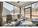 Cozy sunroom featuring neutral-toned furnishings, a ceiling fan, and large windows showcasing serene backyard views at 7133 Yardley St, Gastonia, NC 28056