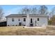 The home's backyard features white brick and a cozy patio area at 7215 Kilcullen Dr, Charlotte, NC 28270