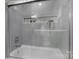 Modern bathroom showcasing a tub with gray subway tile surround and a sleek glass door at 7215 Kilcullen Dr, Charlotte, NC 28270