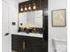 Chic bathroom featuring a double vanity with black accents, a gold mirror, and modern lighting at 7215 Kilcullen Dr, Charlotte, NC 28270
