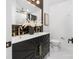 A contemporary bathroom boasts black and gold accents and a stylish double vanity at 7215 Kilcullen Dr, Charlotte, NC 28270