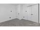 Modern bedroom with fresh white paint, neutral carpet, and a closet with double doors at 7215 Kilcullen Dr, Charlotte, NC 28270