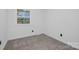 Bright bedroom with a window, neutral carpet, and fresh white paint at 7215 Kilcullen Dr, Charlotte, NC 28270