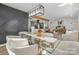 Elegant dining area with a glass table, stylish lighting, and an open view into the living spaces at 7215 Kilcullen Dr, Charlotte, NC 28270