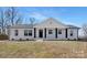 Charming brick home with a welcoming front porch and well-manicured lawn under a bright sky at 7215 Kilcullen Dr, Charlotte, NC 28270