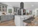 Stylish kitchen with an island, modern appliances, seating and elegant gray cabinets at 7215 Kilcullen Dr, Charlotte, NC 28270