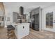 Bright, modern kitchen featuring stainless steel appliances, a center island and elegant gray cabinets at 7215 Kilcullen Dr, Charlotte, NC 28270