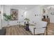 Bright living area featuring modern decor, wood floors, and white armchairs at 7215 Kilcullen Dr, Charlotte, NC 28270