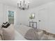 Bright main bedroom features a large bed, chandelier, and natural lighting at 7215 Kilcullen Dr, Charlotte, NC 28270
