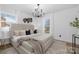 A luxurious main bedroom showcasing a comfortable king bed and modern chandelier at 7215 Kilcullen Dr, Charlotte, NC 28270