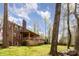 Beautiful brick home with large wooden deck overlooks a lush lawn and mature trees at 748 Saint Cloud Dr, Statesville, NC 28625