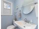 Charming powder room featuring a pedestal sink, stylish fixtures, and serene blue walls at 748 Saint Cloud Dr, Statesville, NC 28625
