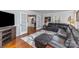 Comfortable living room with a leather sectional, hardwood floors, and French doors leading to an office space at 748 Saint Cloud Dr, Statesville, NC 28625