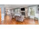 Cozy living room with hardwood floors, a stone fireplace, and plenty of natural light at 748 Saint Cloud Dr, Statesville, NC 28625