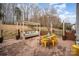 Outdoor dining space features a table with yellow chairs and a pergola with seating at 8134 Chatham Oaks Dr, Concord, NC 28027