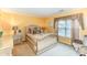 Bright bedroom features decorative pillows, a classic nightstand, and an elegant window treatment at 8134 Chatham Oaks Dr, Concord, NC 28027
