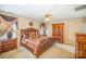 Cozy bedroom with wooden furniture, including a bed and armoire at 8134 Chatham Oaks Dr, Concord, NC 28027
